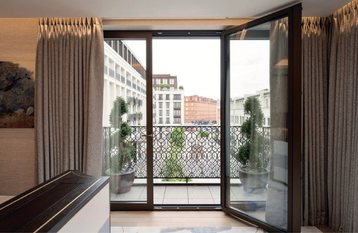 Balcony doors opening onto a decorative iron balcony