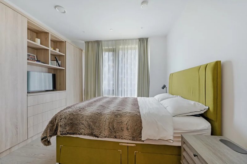 Principal bedroom with green headboard