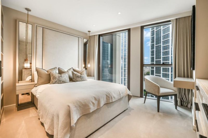 Bedroom with armchair and city views