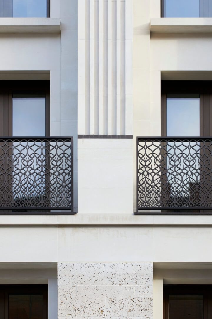Pale stone London facade with decorative iron balconies